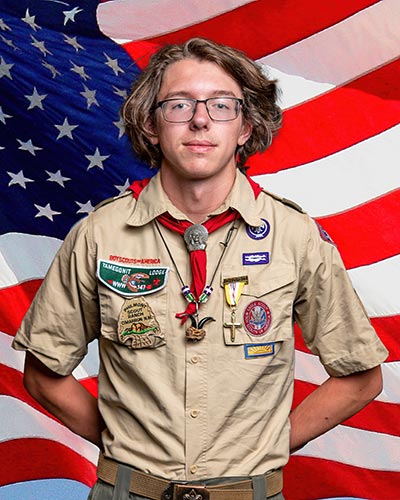 Eagle Scout in front of flag