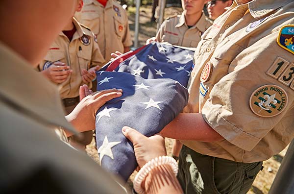 scouts folding a flag